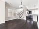 Open-concept living area with dark hardwood floors, large windows, and an adjacent kitchen at 164 Blakemore Dr, Smyrna, GA 30080