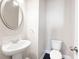Clean, modern powder room with a pedestal sink and a white commode at 164 Blakemore Dr, Smyrna, GA 30080