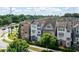 Street view featuring beautiful townhomes, manicured greenery, and street traffic at 164 Blakemore Dr, Smyrna, GA 30080
