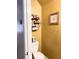 Cozy half bathroom with a decorative shelf, a toilet, and warm-toned walls at 2691 Pointcrest Way, Grayson, GA 30017