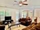 Comfortable living room with ceiling fan, plush seating, and bright windows overlooking the outdoors at 2691 Pointcrest Way, Grayson, GA 30017