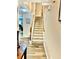 Bright foyer showcasing a carpeted staircase, wood handrail, and lovely wood-look flooring at 2691 Pointcrest Way, Grayson, GA 30017