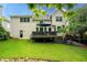 Well-maintained backyard with lush lawn, deck, and mature trees at 3220 Millwood Trl, Smyrna, GA 30080