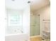 Bright bathroom features soaking tub, shower, and modern fixtures at 620 River Mist Dr, Jonesboro, GA 30238