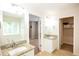 Bathroom features granite countertops and access to a walk-in closet and bedroom at 620 River Mist Dr, Jonesboro, GA 30238