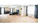 Spacious bedroom features tray ceiling, neutral tones, and carpet flooring at 620 River Mist Dr, Jonesboro, GA 30238