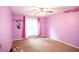 bedroom featuring purple walls, carpet flooring, and a ceiling fan at 620 River Mist Dr, Jonesboro, GA 30238