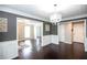 Hardwood floored dining room featuring elegant white wainscoting and large doorways at 620 River Mist Dr, Jonesboro, GA 30238