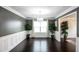 Elegant dining room with dark wood floors, wainscoting, and a decorative chandelier at 620 River Mist Dr, Jonesboro, GA 30238
