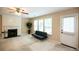 Cozy living area with fireplace, ceiling fan, and view of back yard at 620 River Mist Dr, Jonesboro, GA 30238