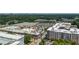 Aerial view of commercial buildings near retail parking lots and residential areas amid green trees at 1282 Kendrick Ne Rd, Brookhaven, GA 30319