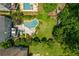 Aerial view of a home's expansive backyard with a uniquely shaped pool, a playground, and lush landscaping at 1282 Kendrick Ne Rd, Brookhaven, GA 30319