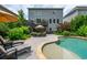 A backyard featuring a lovely pool, patio furniture, lush landscaping and a two-story house with a deck at 1282 Kendrick Ne Rd, Brookhaven, GA 30319