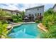The backyard features a lovely pool with a tanning ledge, patio, outdoor seating and a two-story house with a deck at 1282 Kendrick Ne Rd, Brookhaven, GA 30319