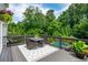 Outdoor deck with dining area overlooking the lush backyard and swimming pool at 1282 Kendrick Ne Rd, Brookhaven, GA 30319