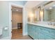 Stylish bathroom with double vanity, light blue cabinets, and access to another room at 1282 Kendrick Ne Rd, Brookhaven, GA 30319