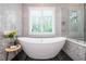 Beautiful bathroom with freestanding tub, mosaic tile wall, and plantation shutters at 1282 Kendrick Ne Rd, Brookhaven, GA 30319