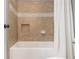Classic tiled bathroom features shower-tub combo with inset shelf and a white shower curtain at 1282 Kendrick Ne Rd, Brookhaven, GA 30319