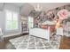 Charming bedroom with hardwood floors, decorative wallpaper, and ample natural light from the windows at 1282 Kendrick Ne Rd, Brookhaven, GA 30319