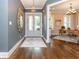 Inviting foyer with hardwood floors, decorative mirror, and view into a sunlit office at 1282 Kendrick Ne Rd, Brookhaven, GA 30319