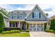 Charming two-story home featuring a well-manicured lawn, beautiful landscaping and a gray accent garage at 1282 Kendrick Ne Rd, Brookhaven, GA 30319