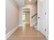 Bright hallway with hardwood floors leading to a staircase and another room at 1282 Kendrick Ne Rd, Brookhaven, GA 30319