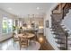 Eat-in kitchen with a table, view of stainless appliances, island seating, and staircase in the background at 1282 Kendrick Ne Rd, Brookhaven, GA 30319