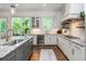 Gourmet kitchen featuring custom cabinets, granite counters, wine cooler, and stainless steel appliances at 1282 Kendrick Ne Rd, Brookhaven, GA 30319