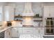 Bright kitchen with stainless steel appliances, granite counters, decorative backsplash, and custom range hood at 1282 Kendrick Ne Rd, Brookhaven, GA 30319