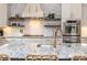Kitchen with stainless appliances, granite counters, decorative backsplash, island, and stylish fixtures at 1282 Kendrick Ne Rd, Brookhaven, GA 30319