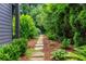 A charming stone pathway lined with lush landscaping, creating a serene and inviting outdoor space at 1282 Kendrick Ne Rd, Brookhaven, GA 30319