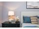 Close-up of bedside table with lamp, flowers, and artwork in main bedroom at 1282 Kendrick Ne Rd, Brookhaven, GA 30319