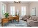 Bright home office featuring plantation shutters, a wooden desk, and comfortable seating at 1282 Kendrick Ne Rd, Brookhaven, GA 30319