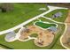 Community playground featuring multiple play structures, swings, slides, and shaded picnic areas surrounded by green space at 1282 Kendrick Ne Rd, Brookhaven, GA 30319