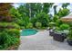 Gorgeous backyard pool and patio with lounge chairs and lush landscaping at 1282 Kendrick Ne Rd, Brookhaven, GA 30319