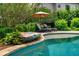 A beautiful pool with a rock waterfall feature and lounge chairs, perfect for relaxing and enjoying the outdoors at 1282 Kendrick Ne Rd, Brookhaven, GA 30319