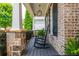 Inviting front porch featuring a classic rocking chair, stone accents, and a charming pendant light at 1282 Kendrick Ne Rd, Brookhaven, GA 30319