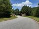 Stone pillar gate entrance with trees and blue sky for a private community at 4309 Giverney Blvd, Fairburn, GA 30213