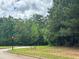 Corner lot featuring mature trees and Giverny Way street sign at 4309 Giverney Blvd, Fairburn, GA 30213