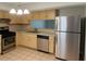 Kitchen with stainless steel appliances, wooden cabinets and stone countertops at 5581 Marbut Rd, Lithonia, GA 30058