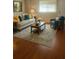 A brightly lit living room with a neutral sofa and a plush blue chair at 5581 Marbut Rd, Lithonia, GA 30058