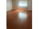 An empty Living Room with laminate flooring and a window at 5581 Marbut Rd, Lithonia, GA 30058