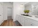 Bright bathroom features a double sink vanity, decorative rug, and a walk-in closet at 1313 Pj East Rd, Covington, GA 30014
