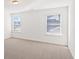 Neutral bedroom featuring carpeting, white walls and trim and two windows at 1313 Pj East Rd, Covington, GA 30014