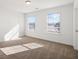 Bright bedroom featuring neutral carpeting and two large windows at 1313 Pj East Rd, Covington, GA 30014