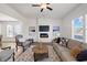 Cozy living room featuring a modern fireplace, ceiling fan, and comfortable sofa seating at 1313 Pj East Rd, Covington, GA 30014