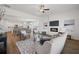 Open-concept living room with fireplace, sofa, and views into kitchen and dining areas at 1313 Pj East Rd, Covington, GA 30014