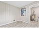Cozy room featuring paneling, a heater, light grey floors and utilities behind a door at 190 Judy Sw Ln, Atlanta, GA 30315