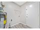 Utility room with modern water heater, grey floors and white door at 190 Judy Sw Ln, Atlanta, GA 30315