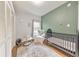 Cozy Bedroom featuring a crib, chair, area rug, and white closet at 222 Bishop Ne Dr, Marietta, GA 30060